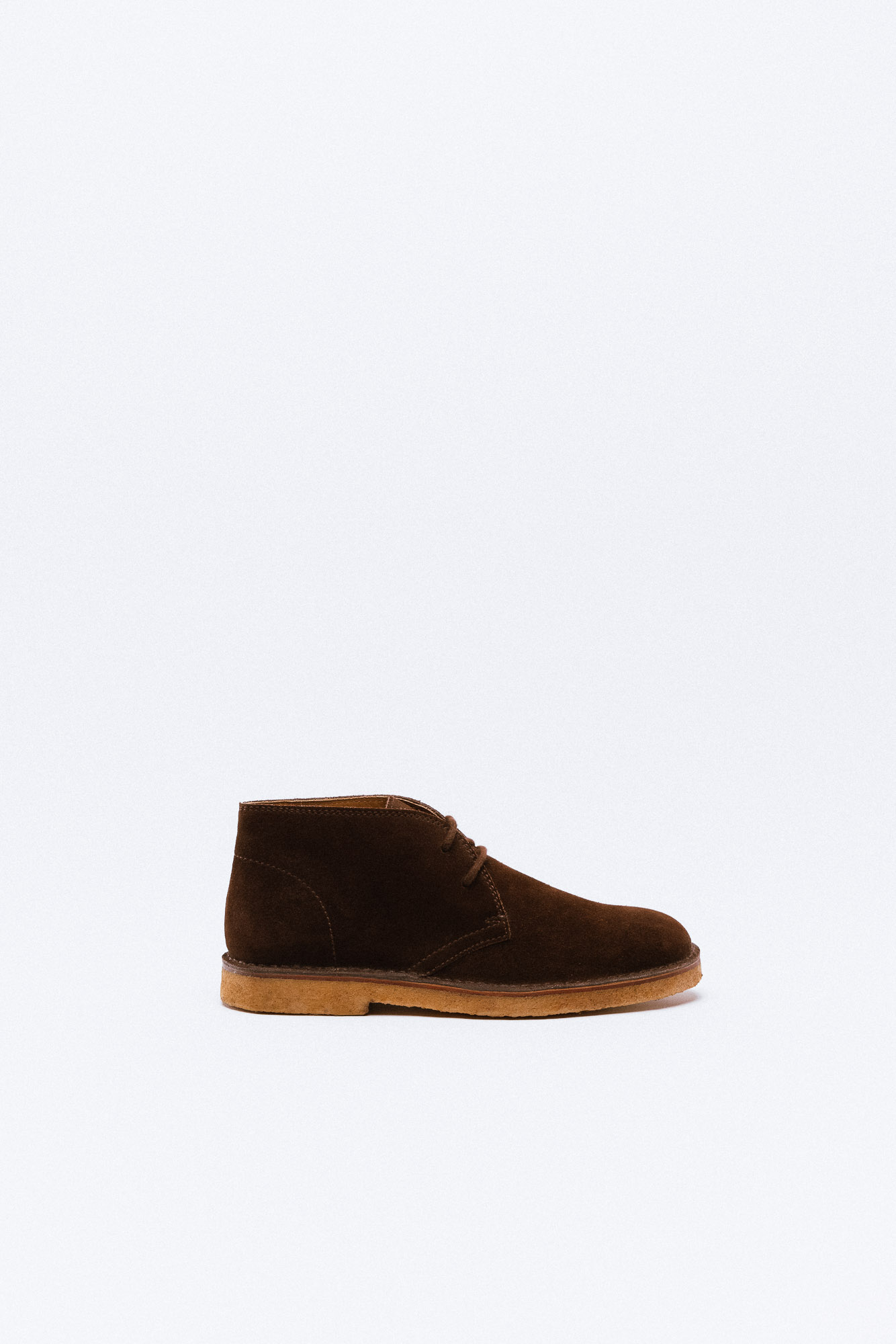 A brown suede desert boot with crepe rubber sole.