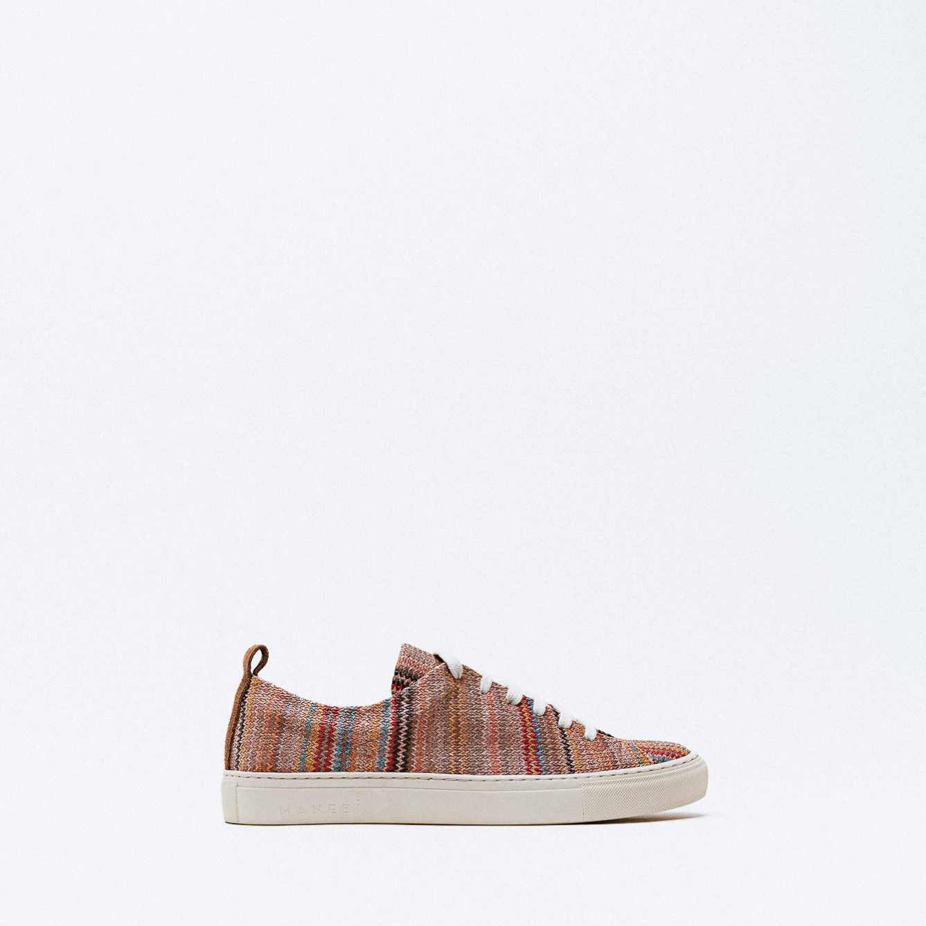 A striped knit fabric sneaker in earthy tones with white laces and sole.