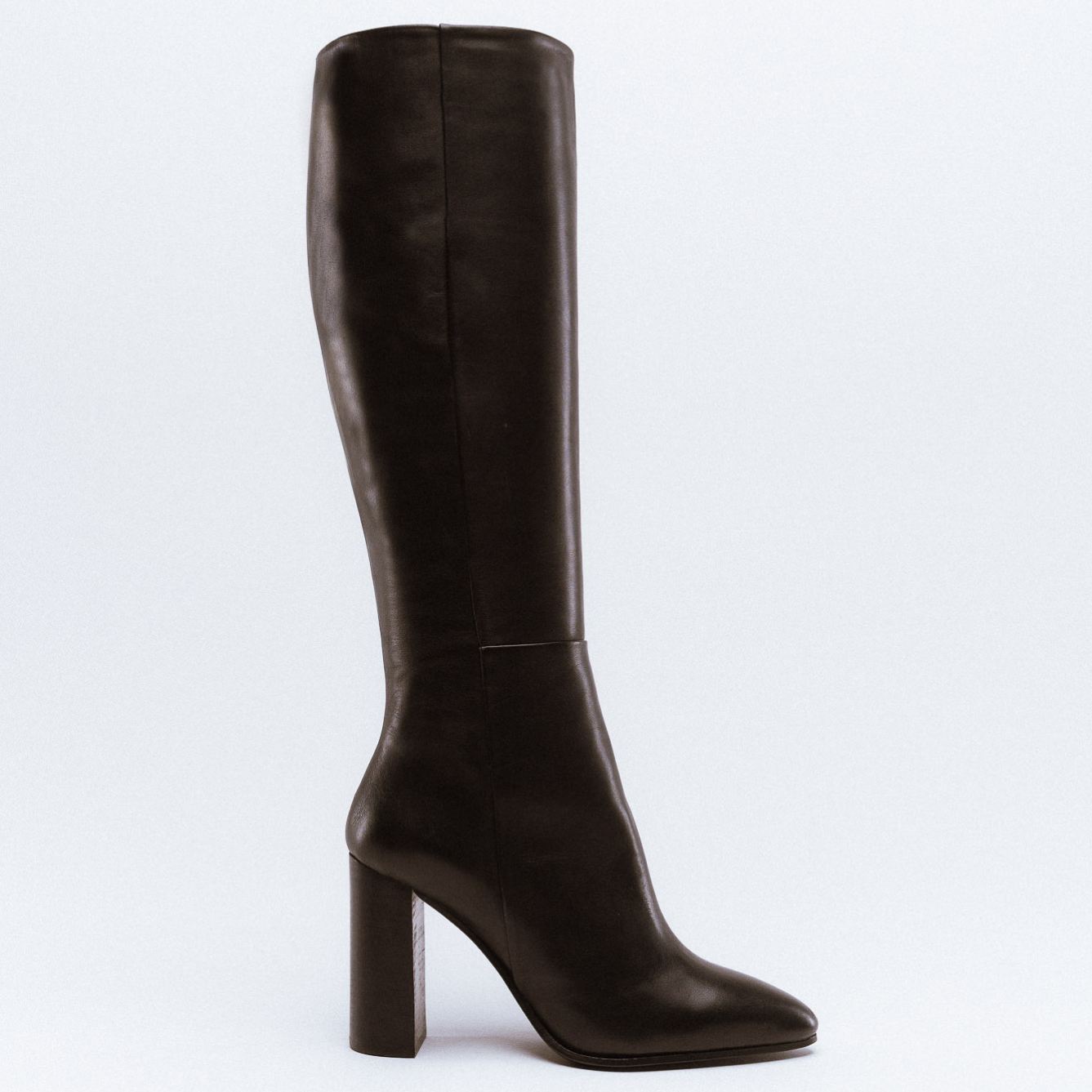 A tall dark brown leather boot with a chunky high heel and knee-high shaft.