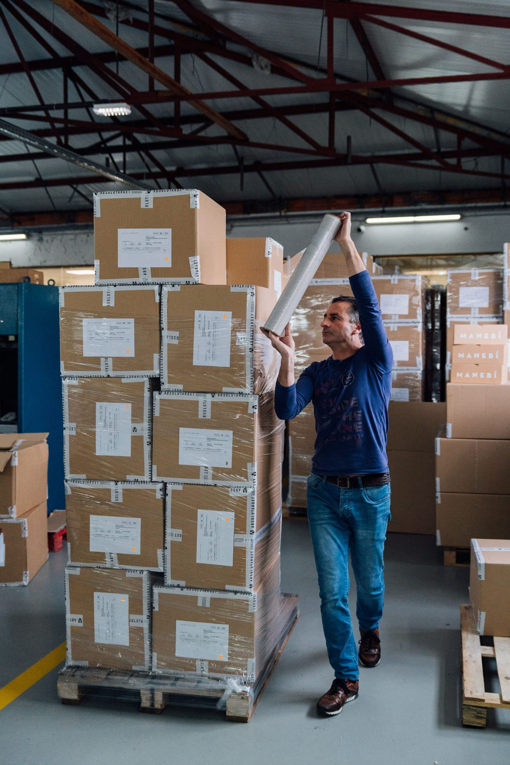 Factory worker packing the goods for delivery.