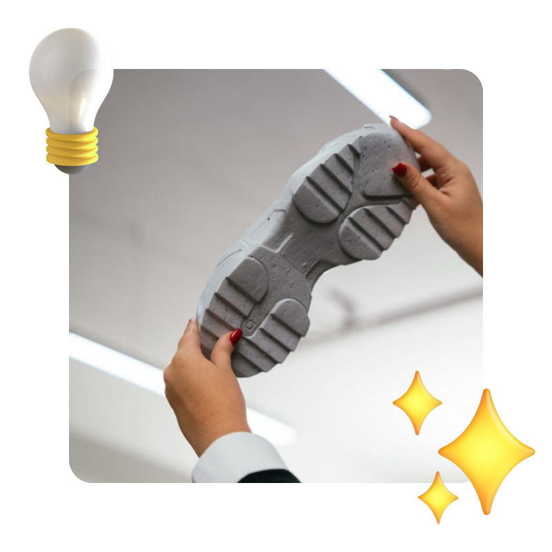 Portugal Shoe worker elevating a gray shoe sole in order to analyze it.